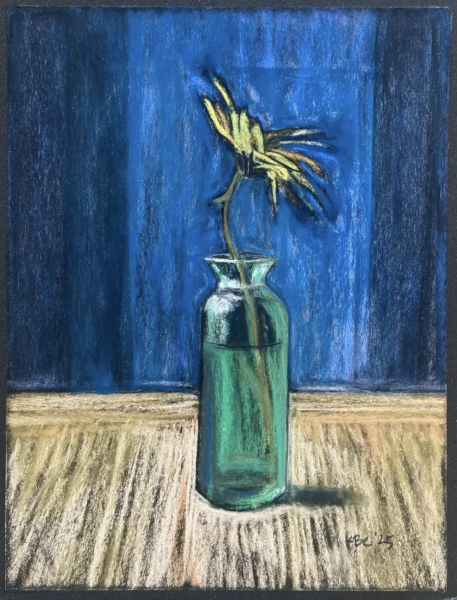 Brittlebrush Flower  is a pastel-style still life of a single yellow flower with drooping petals in a green glass bottle, set on a wooden surface against a deep blue background.