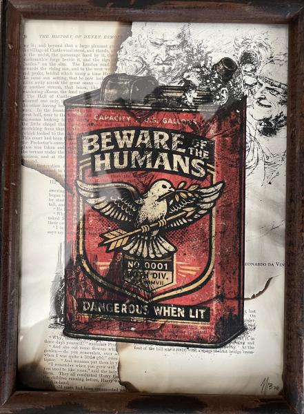 Dangerous When Lit by Joe Beraldo Framed mixed-media artwork featuring a vintage red gasoline can labeled “Beware the Humans” with an eagle emblem and the phrase “Dangerous When Lit,” layered over antique book pages and detailed black-and-white illustrations.
