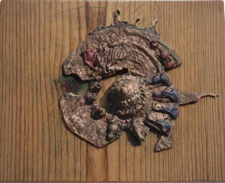Earth's Heart by Angeles Guzman Mixed-media relief sculpture mounted on a square wooden panel, featuring an abstract, textured organic form in earthy brown and copper tones with subtle green accents.