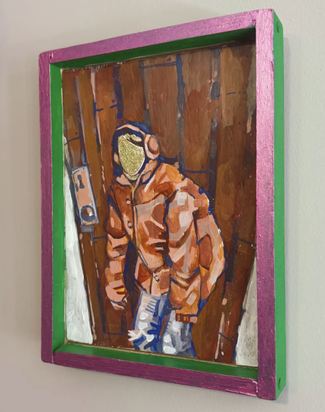 “face value”  by Eden Andrulaitis is a Mixed-media painting of a faceless figure in an orange jacket and headphones standing against a wooden background, framed in a bright pink and green shadowbox frame.