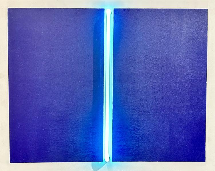 "Measured Hope" by Rod Lathim is a minimalist wall artwork featuring two deep blue panels separated by a vertical glowing turquoise neon light. The piece is framed in white and mounted against a light-colored wall, creating a strong contrast between the dark blue fields and the bright central light strip.