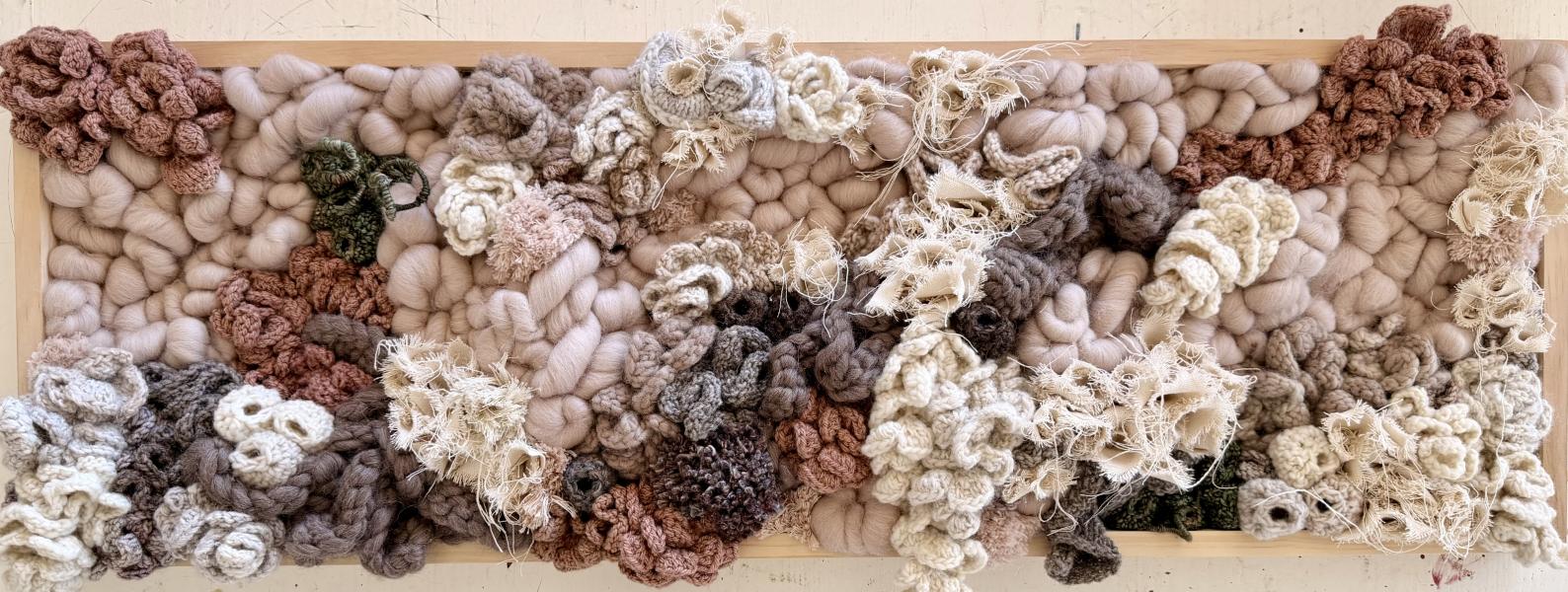 They Dance in the Daylight by Kellen Meyer Textile wall artwork featuring thick woven wool, yarn, and crocheted elements in soft neutral tones—cream, blush, taupe, and brown—arranged in an organic, layered composition within a light wood frame.