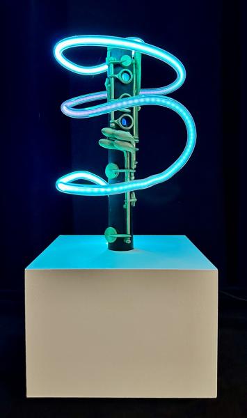Rod Lathim Contemporary sculpture of a saxophone wrapped in glowing blue neon tubing displayed on a pedestal.